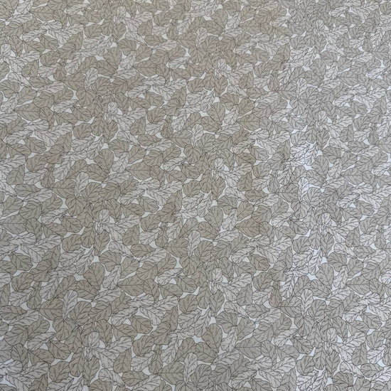 Cream cotton fabric with delicate leaf print pattern