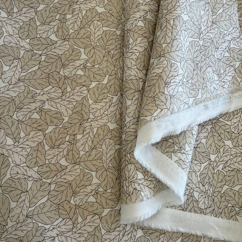 Cream cotton fabric with delicate leaf print pattern