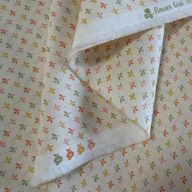 Flower Girl cotton fabric by Sew Quilty Life with small pastel leaf sprigs on cream background