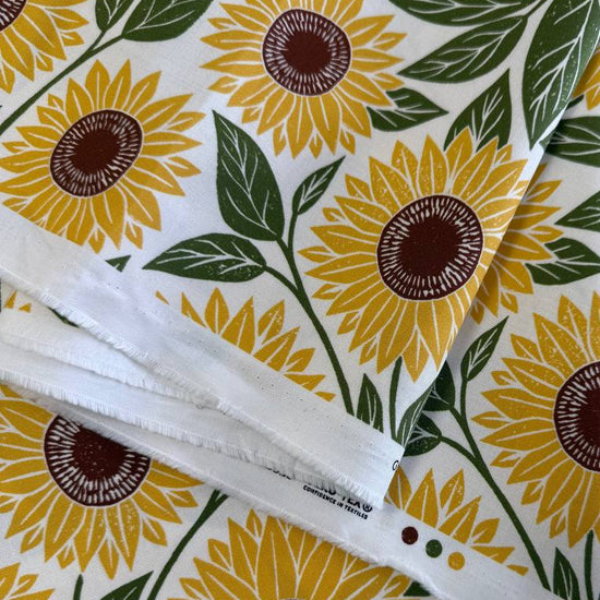 Sunflower cotton fabric by Katharine Watson for Moda, Garden Series, cream background with yellow sunflowers and green leaves