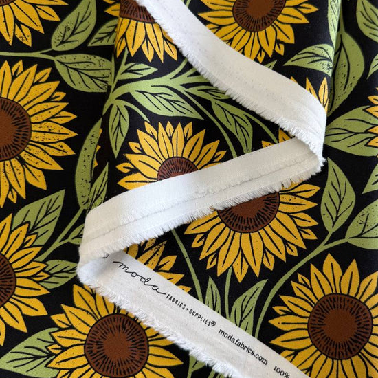 Sunflower cotton fabric with yellow sunflowers and green leaves on black background Garden Series by Katharine Watson Moda