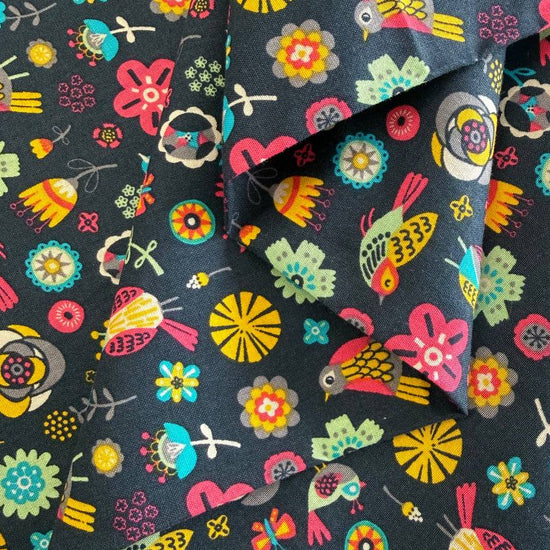 Colorful birds and flowers quilting cotton fabric on dark background from Camelot Fabrics Emma & Mila collection