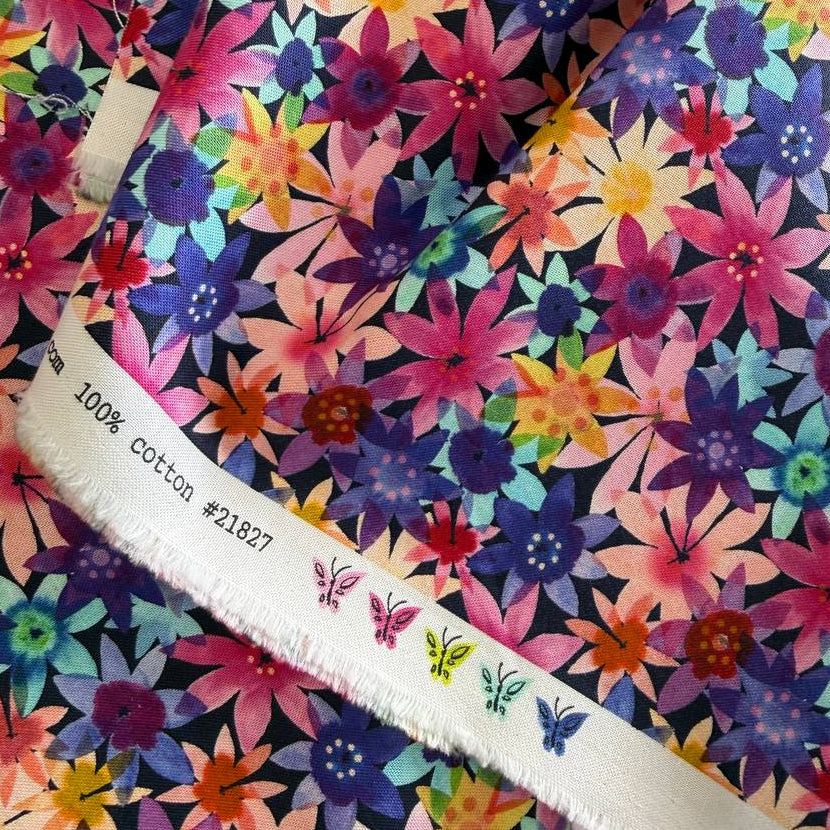 Colorful watercolor floral cotton fabric with layered pink, purple, blue, yellow and coral flowers on dark background – Flower Patches by Amarilys Henderson for Moda