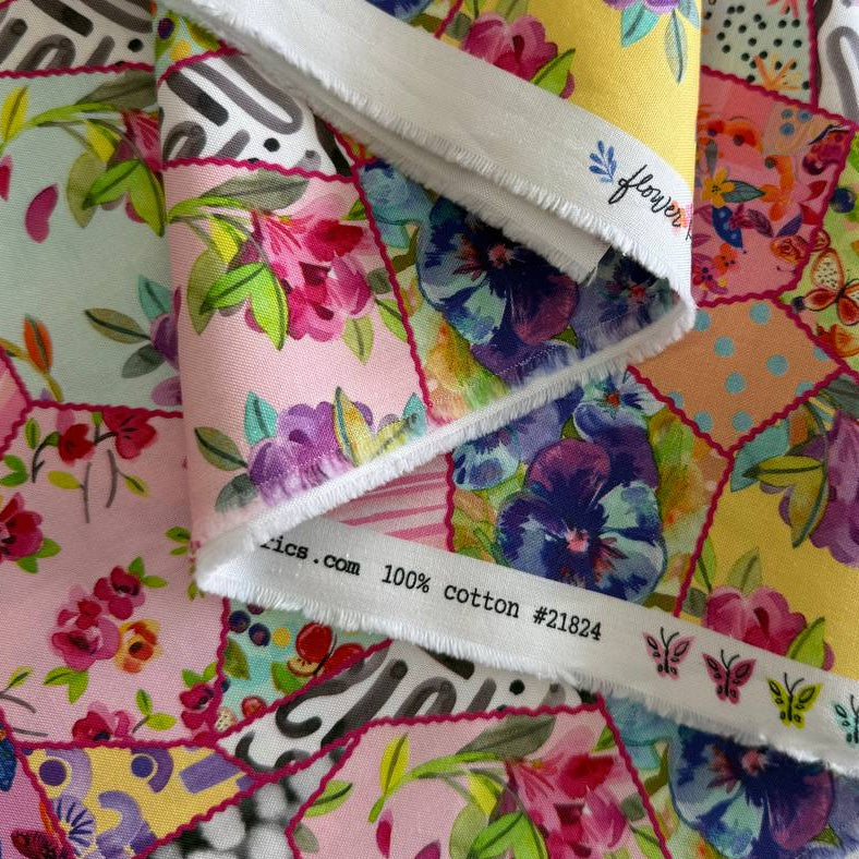 Colorful floral patchwork quilting cotton fabric with hexagon blocks, butterflies, and multicolor flowers by Amarilys Henderson for Moda Flower Patches 1824-11
