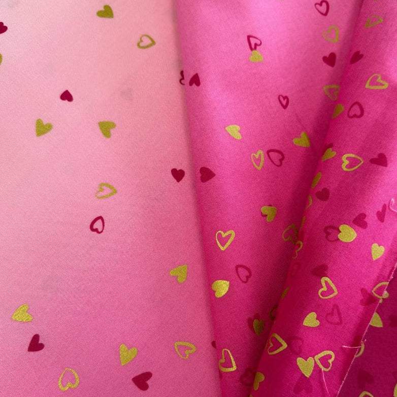 Pink ombre cotton fabric with small metallic gold and red hearts by Moda Fabric