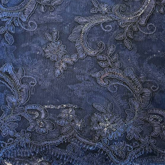 Navy embroidered floral lace fabric with shimmering sequins on a soft mesh base, perfect for formal dresses, bridal wear, and elegant sewing projects.