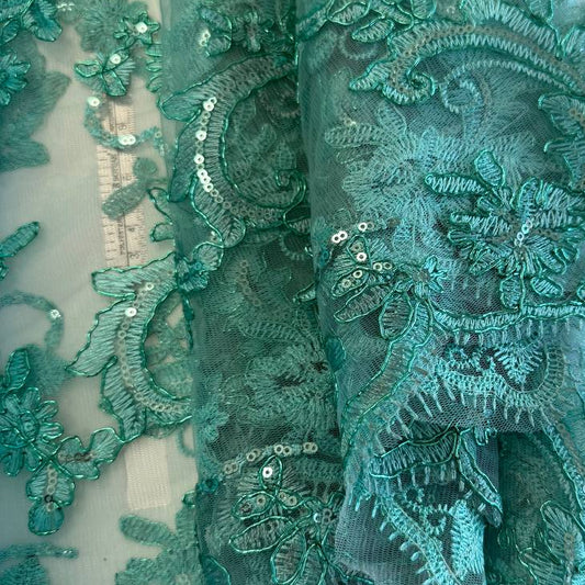 Mint green embroidered floral lace with shimmering sequins on a soft sheer mesh background, featuring elegant scalloped edges, ideal for bridal wear, evening gowns, and formal sewing projects.