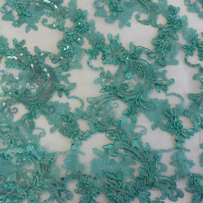 Mint green embroidered floral lace with shimmering sequins on a soft sheer mesh background, featuring elegant scalloped edges, ideal for bridal wear, evening gowns, and formal sewing projects.