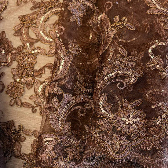 Elegant brown embroidered floral lace with shimmering sequins on a soft sheer mesh base, finished with a scalloped edge, ideal for evening gowns, formalwear, and bridal sewing projects.