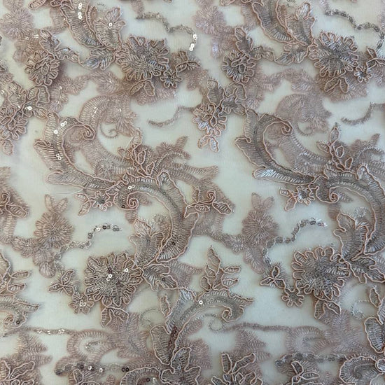 Blush pink embroidered floral lace with delicate sequins on a soft sheer mesh base, featuring an elegant scalloped edge, perfect for bridal gowns, evening dresses, and special occasion sewing projects.