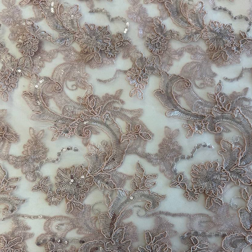Blush pink embroidered floral lace with delicate sequins on a soft sheer mesh base, featuring an elegant scalloped edge, perfect for bridal gowns, evening dresses, and special occasion sewing projects.