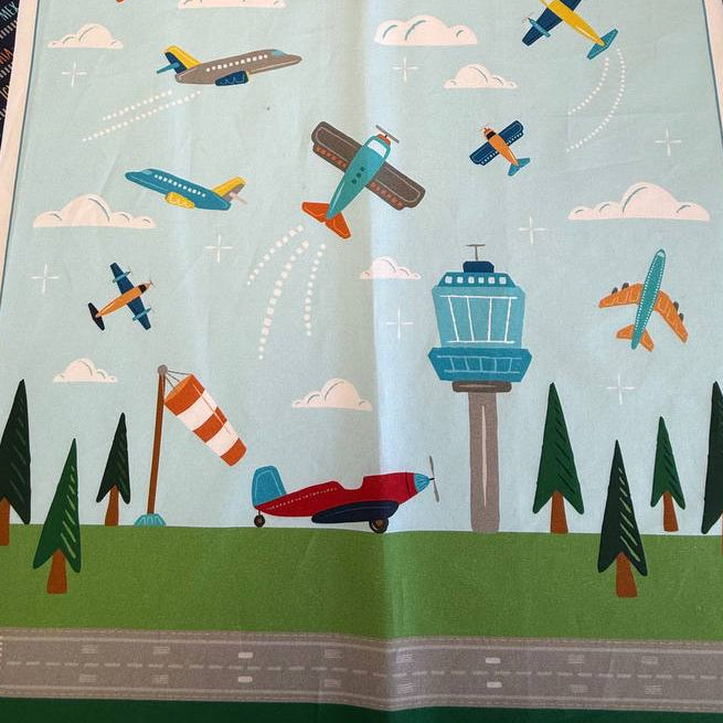 Aviation Adventures airplane cotton fabric panel by Michael Miller with colorful planes sky clouds airport tower blue background