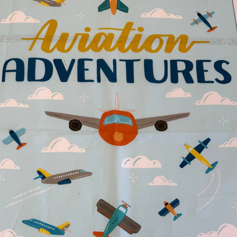 Aviation Adventures airplane cotton fabric panel by Michael Miller with colorful planes sky clouds airport tower blue background