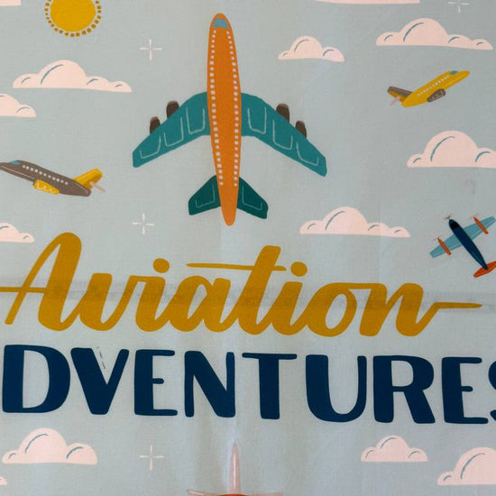Aviation Adventures airplane cotton fabric panel by Michael Miller with colorful planes sky clouds airport tower blue background
