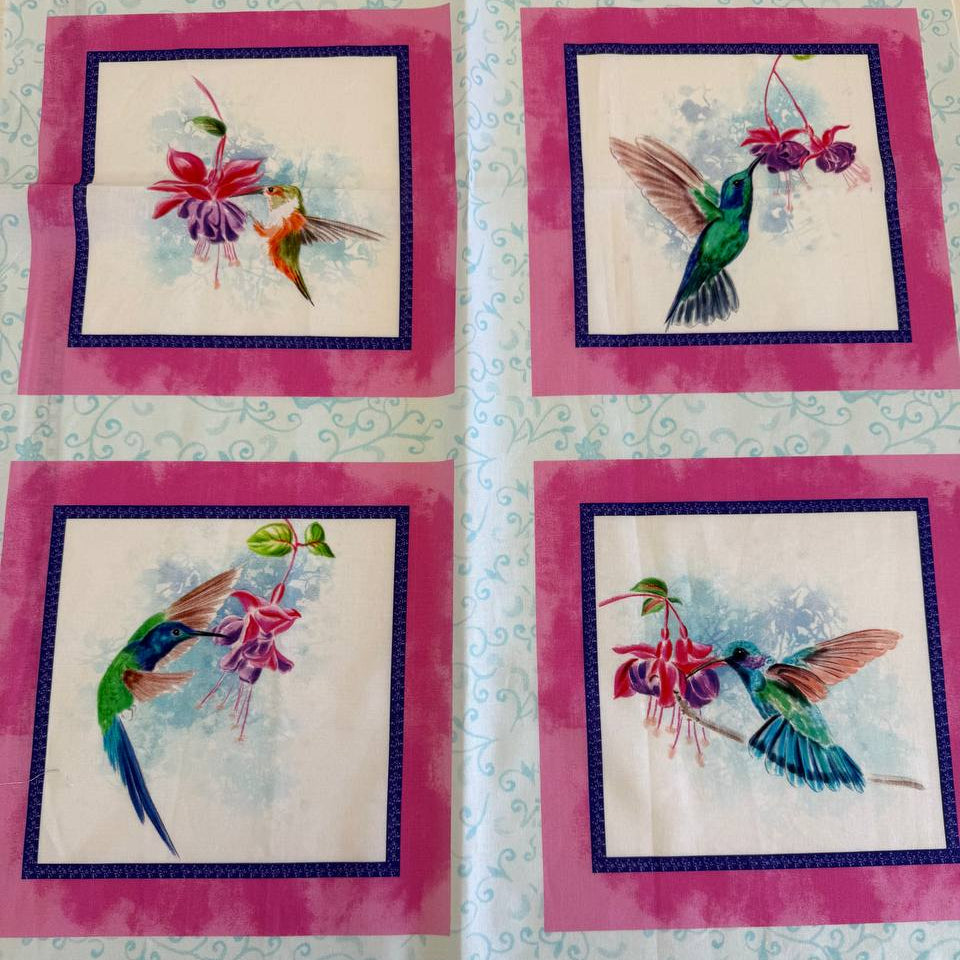 Painted Garden hummingbird cotton fabric panel with pink framed squares and colorful birds with fuchsia flowers on light blue background