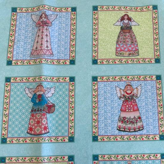 Garden Angels cotton fabric panel with six floral angel blocks on teal background quilting panel