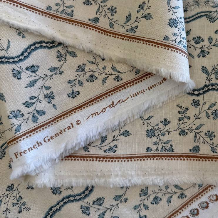 Fleur De Paris Pearl French Blue floral border cotton fabric by Moda with delicate blue flowers on pearl background