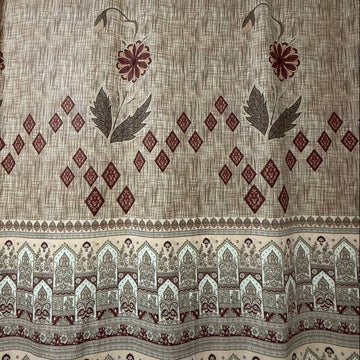 Beige cotton sheeting fabric with burgundy floral motifs, geometric diamonds, and ornamental border design, 108 inch wide bedding fabric displayed at Sasha's Atelier