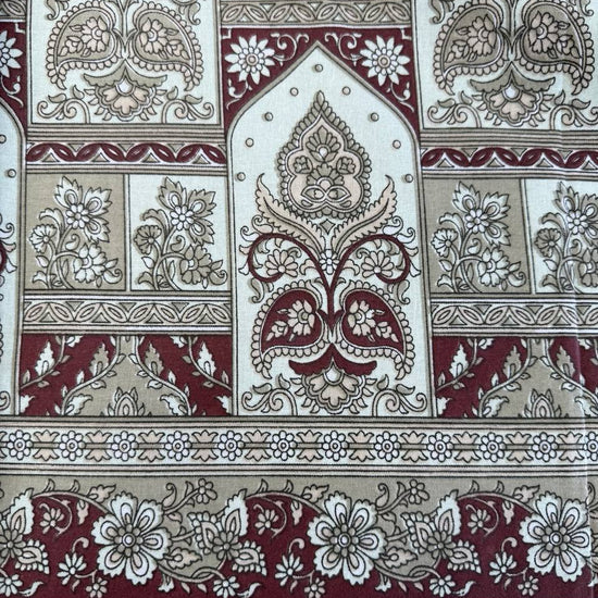 Beige cotton sheeting fabric with burgundy floral motifs, geometric diamonds, and ornamental border design, 108 inch wide bedding fabric displayed at Sasha's Atelier