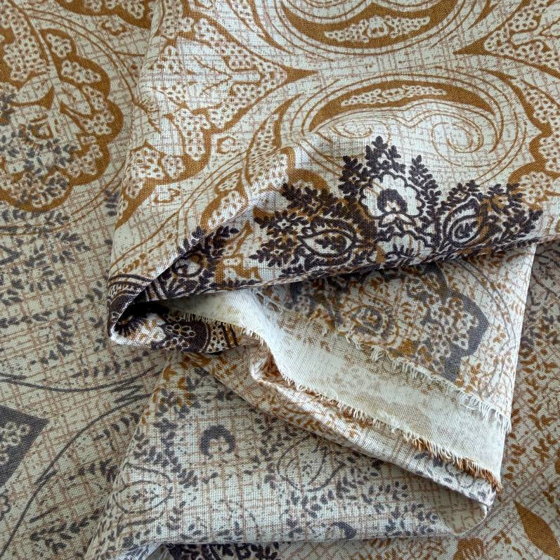 Vintage beige and grey medallion cotton sheeting fabric 108 inch wide folded stack