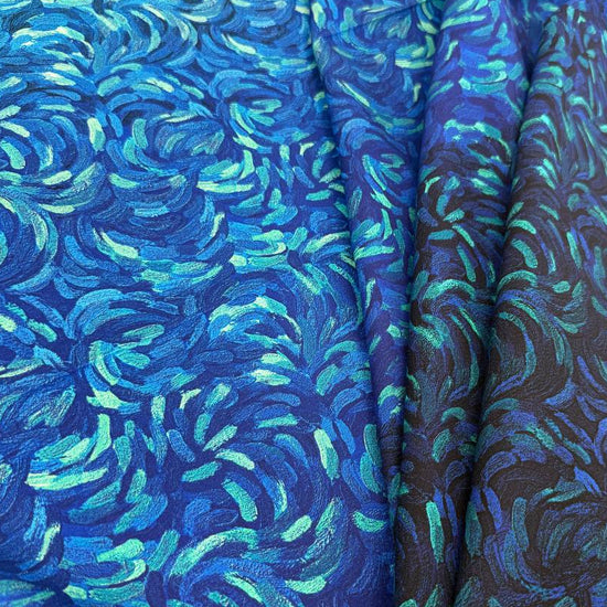 Northcott Starry Night dark blue multi ombre cotton fabric featuring swirling turquoise and royal blue brushstrokes fading into deep navy.