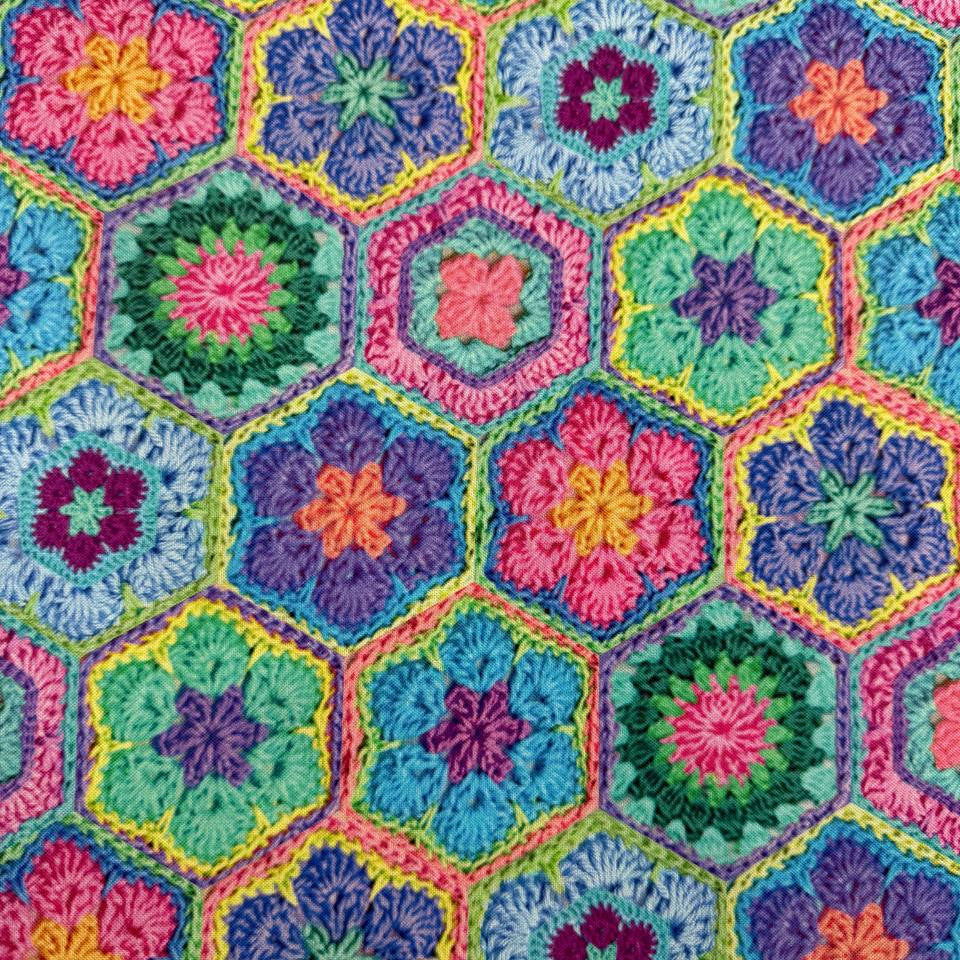 Colourful Northcott Topsy Turtles Crochet Hexie cotton fabric featuring vibrant floral hexagons in pink, purple, turquoise, green, blue and yellow.