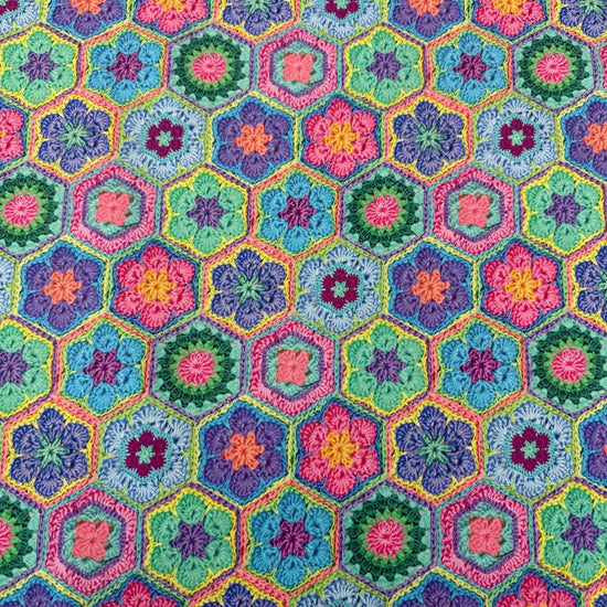 Colourful Northcott Topsy Turtles Crochet Hexie cotton fabric featuring vibrant floral hexagons in pink, purple, turquoise, green, blue and yellow.