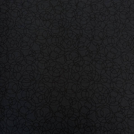 Black cotton quilting fabric by Patrick Lose featuring overlapping geometric circles in a subtle tone-on-tone pattern.