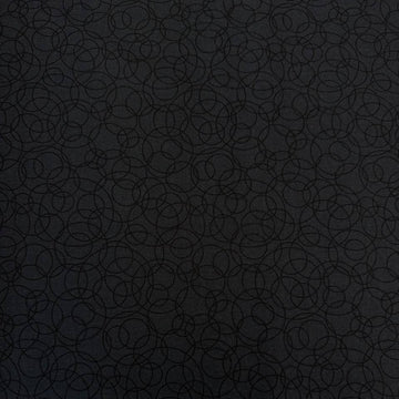 Black cotton quilting fabric by Patrick Lose featuring overlapping geometric circles in a subtle tone-on-tone pattern.