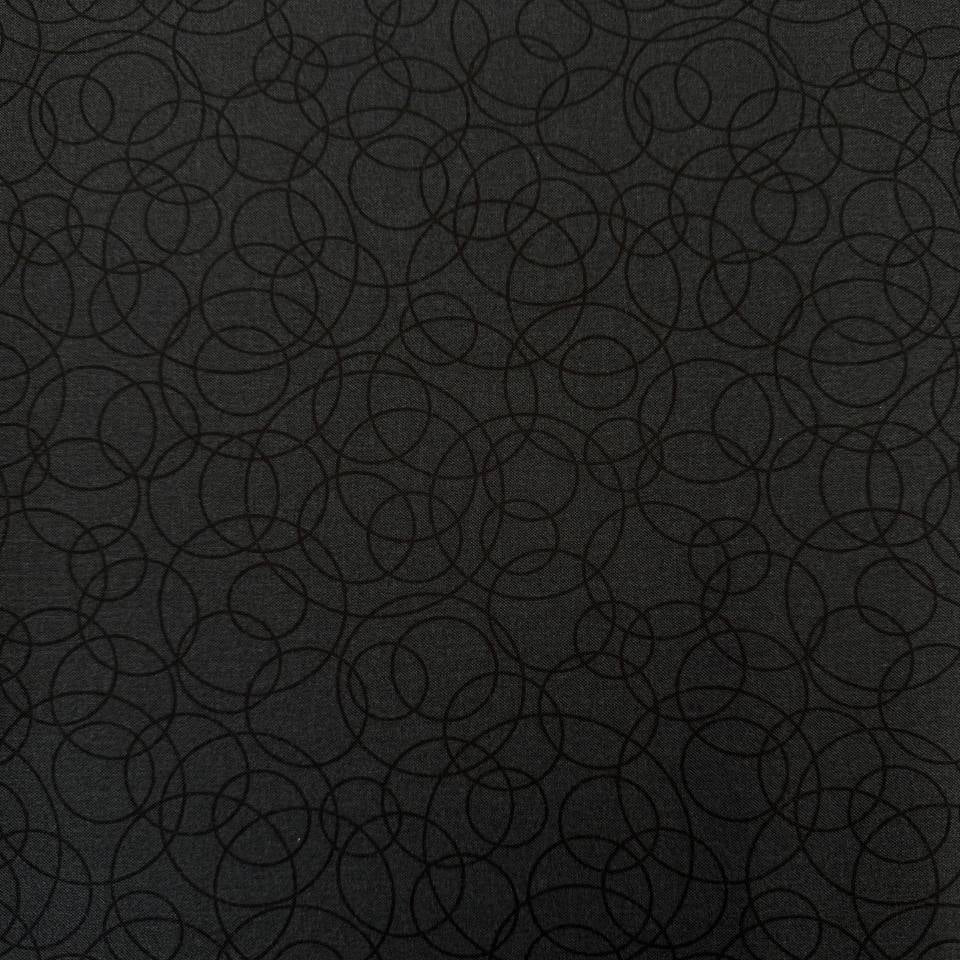 Black cotton quilting fabric by Patrick Lose featuring overlapping geometric circles in a subtle tone-on-tone pattern.