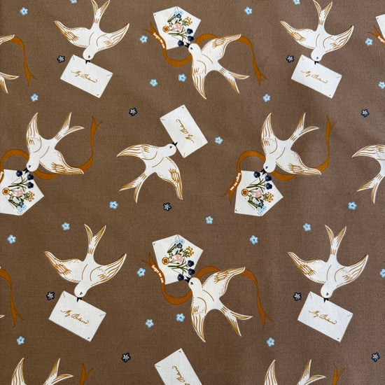 Bird print cotton fabric in teak brown with floral accents by Moda Enchantment collection