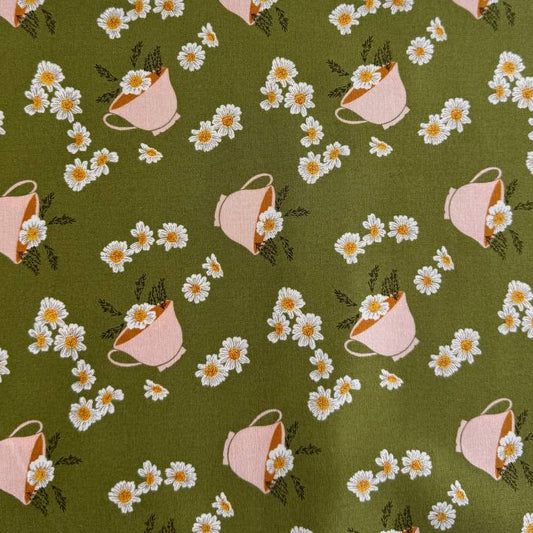 Frivolity cotton fabric with daisies and teacups in green and blush tones