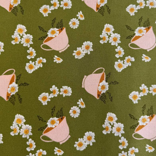 Frivolity cotton fabric with daisies and teacups in green and blush tones