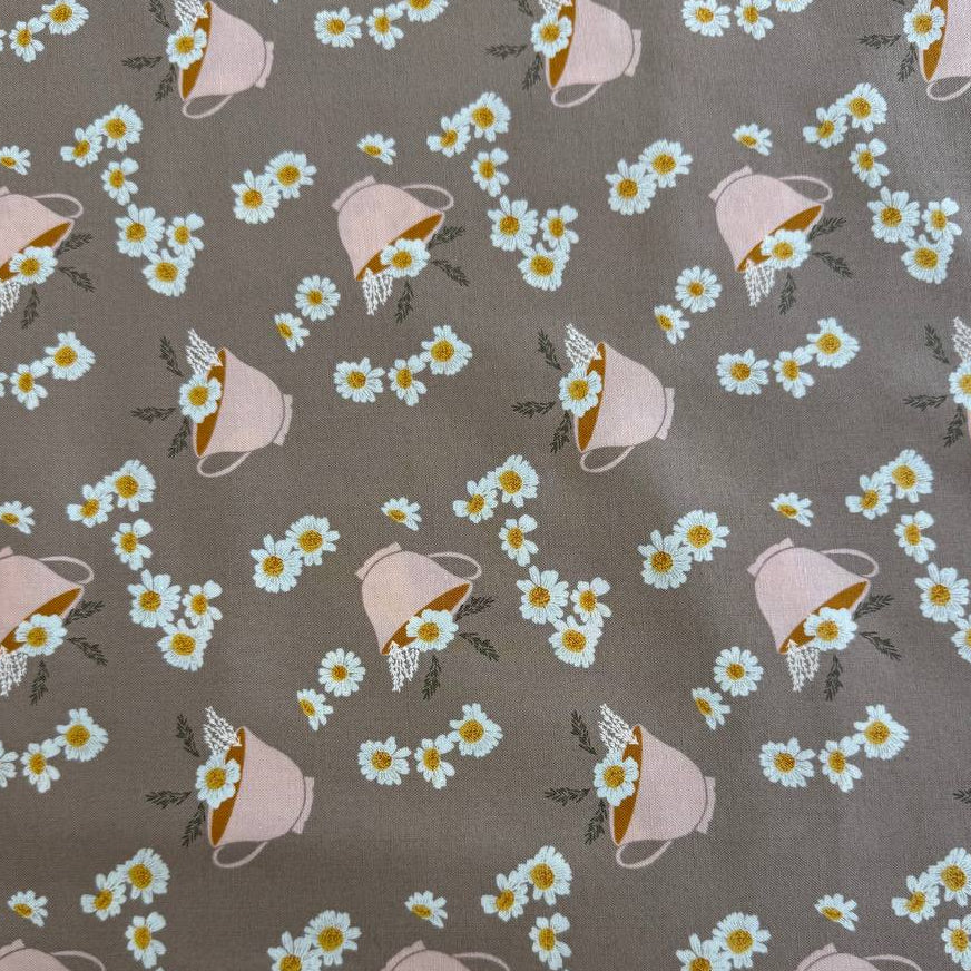 Frivolity cotton fabric with daisies and teacups in green and blush tones
