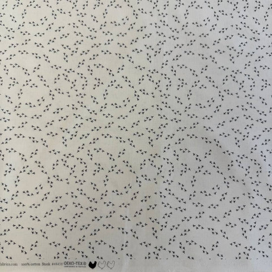 Cream cotton fabric with small black bird footprint pattern from The Henhouse collection by Gingiber for Moda