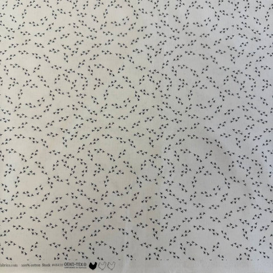 Cream cotton fabric with small black bird footprint pattern from The Henhouse collection by Gingiber for Moda