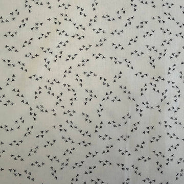 Cream cotton fabric with small black bird footprint pattern from The Henhouse collection by Gingiber for Moda