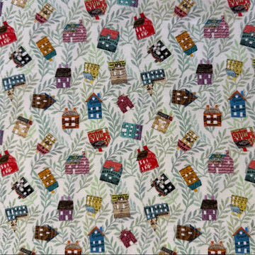 Paper Hamlet fabric by Moda with colorful houses on a light green leafy background