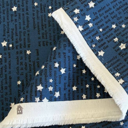 Midnight blue cotton fabric with vintage text print and scattered ivory stars from Paper Hamlet collection by Moda