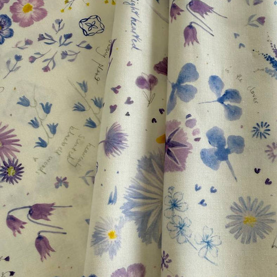 Delphinium Snowdrop floral cotton fabric by Jane Clare for Moda with soft purple and blue flowers on cream background