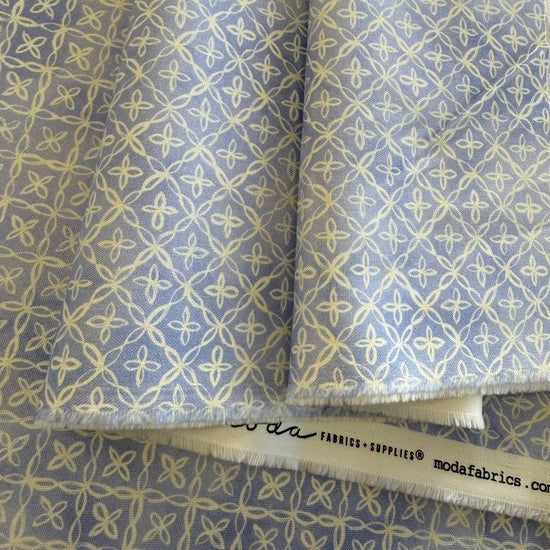 Lilac cotton fabric with delicate cream geometric floral lattice pattern
