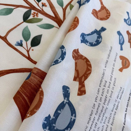 Light cream family tree fabric panel with birds and tree illustration