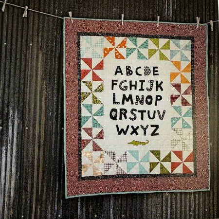 ABC baby quilt pattern with alphabet letters and colorful patchwork border Sweetwater