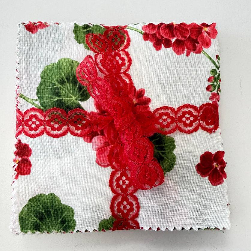 Bettys Geranium charm pack floral quilting cotton squares with red flowers and green leaves