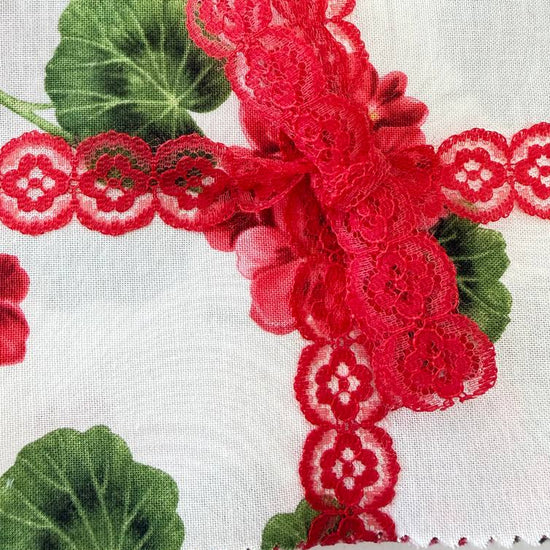 Bettys Geranium charm pack floral quilting cotton squares with red flowers and green leaves