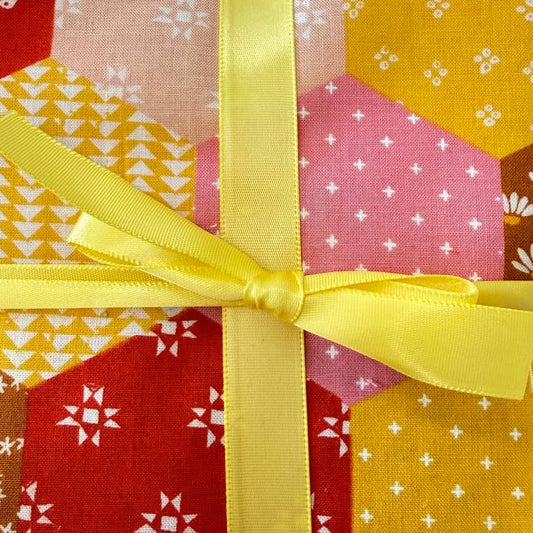 Honey charm pack quilting cotton squares in yellow pink and orange geometric patterns