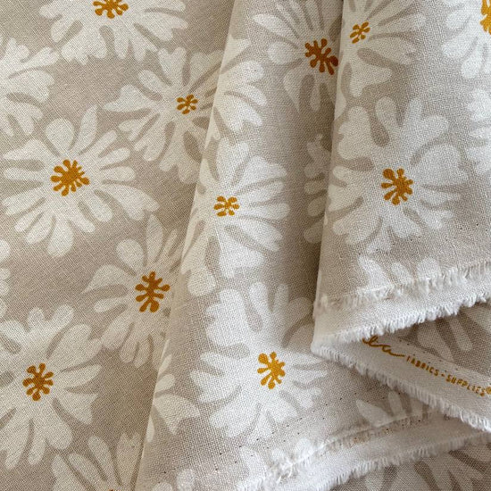 Beige linen fabric with white floral print and mustard accents by Moda Urban Whisper Zen Chic