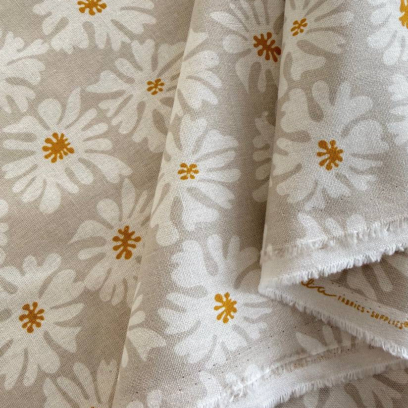 Beige linen fabric with white floral print and mustard accents by Moda Urban Whisper Zen Chic