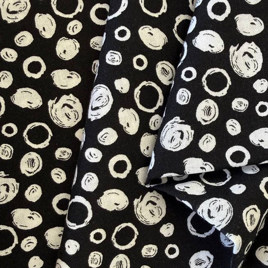 Black and white cotton fabric with abstract scribble dot pattern