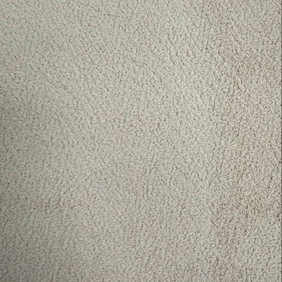 Natural beige sherpa fleece fabric with soft plush texture
